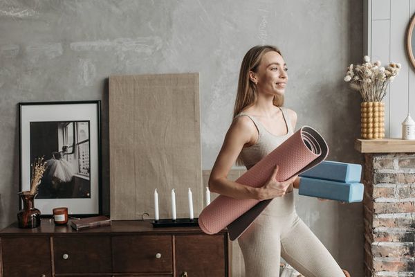 Yoga mats and candles in a dark cozy studio room
